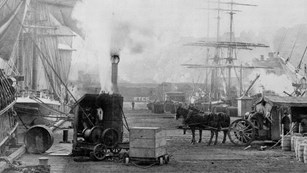 A black and white photo of a SF wharf.