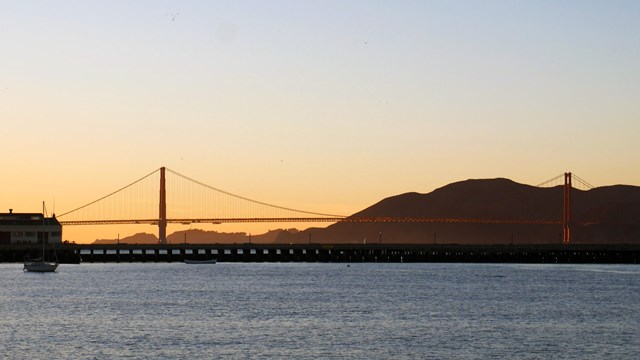 Sunset view of the Golden Gate Bridge from Aquatic Park Cove