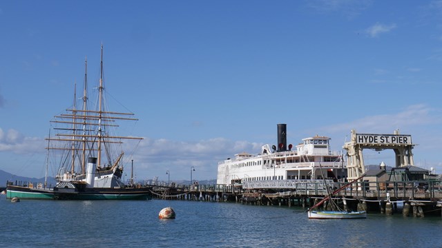 the ships Balclutha, Eppleton Hall, and Eureka docked to the historic Hyde Street Pier.