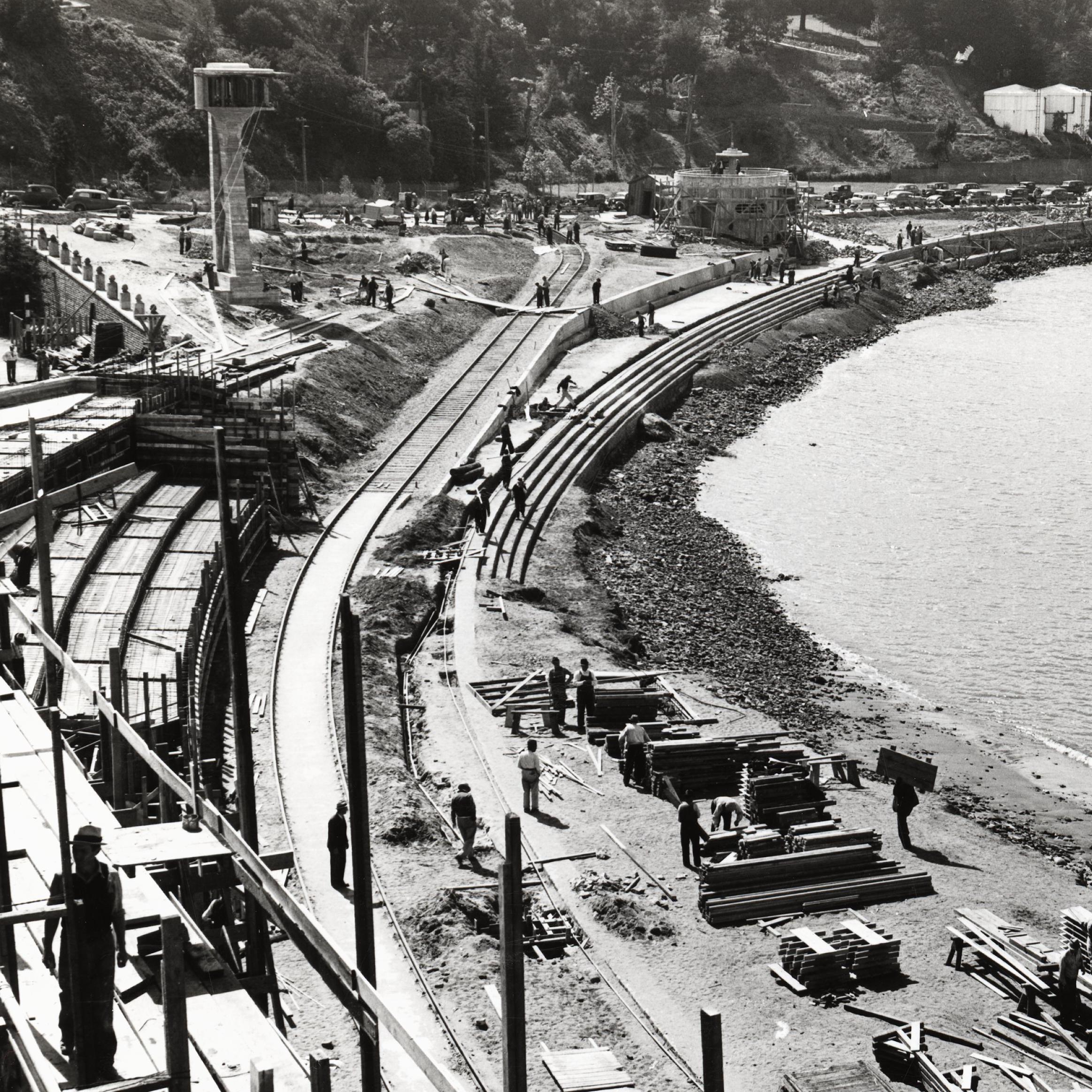historical photo of the Aquatic Park Bathhouse being built, with scaffolding along the shoreline.