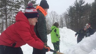 Kids digging in snow 