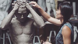 Zoe Dufour working on statue