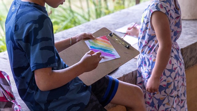 two children painting with watercolors