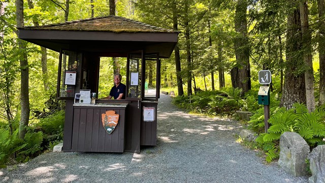 volunteer seated in entry kiosk