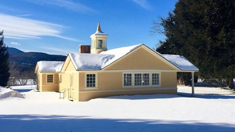Blow-Me-Down Farm Dancehall building in winter with bright blue sky