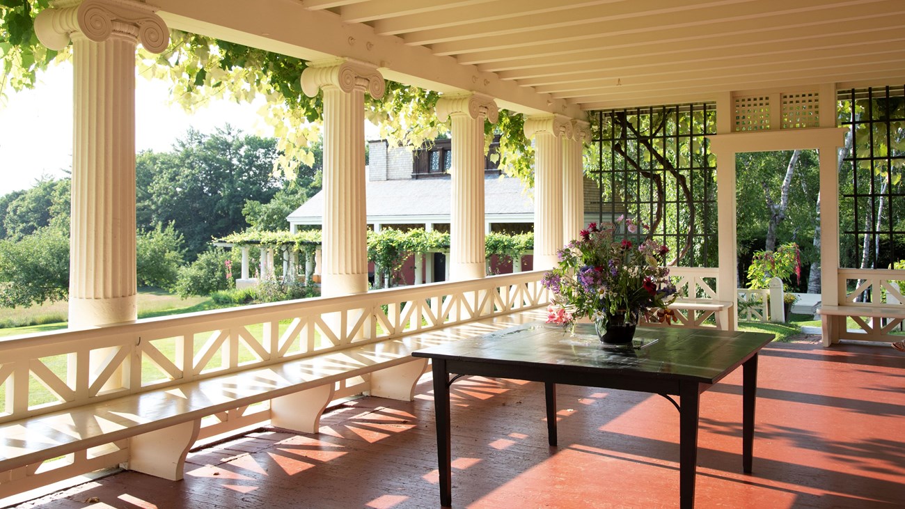large porch with table and flower arrangement