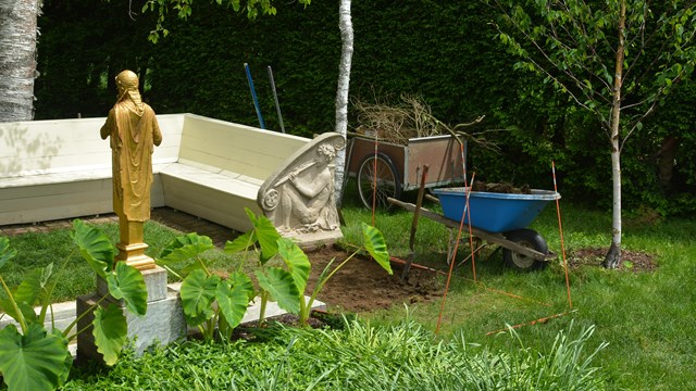 wheel barrel by gilded statue