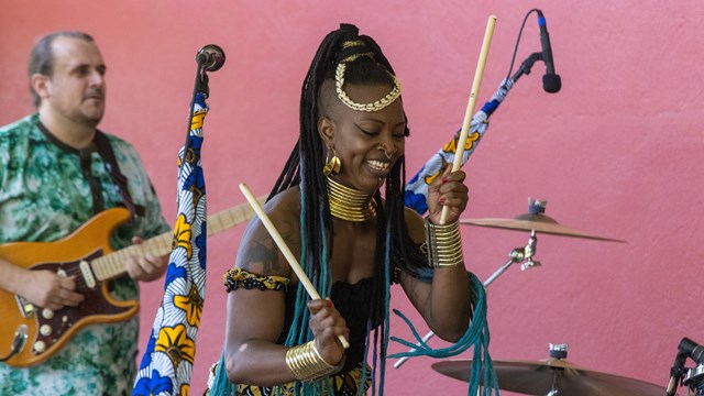 Performer holds drum sticks during summer concert