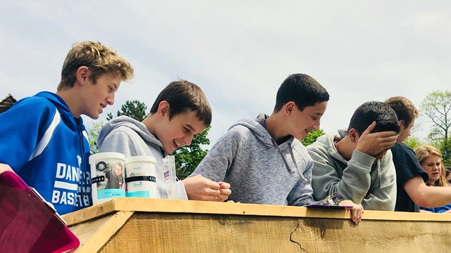 Students stand on a bridge. 