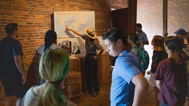 Students stand inside a brick building. 