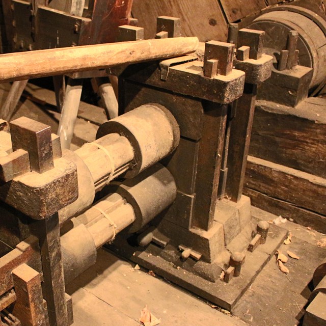 building interior with wooden machinery used to reshape iron
