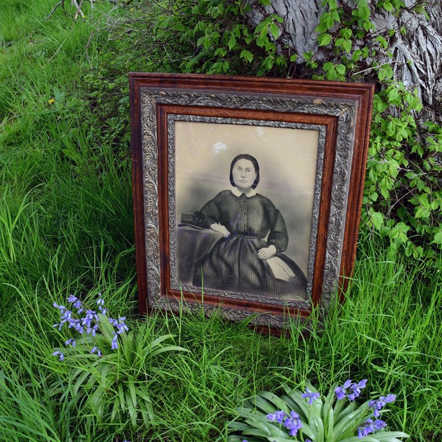 Historic portrait of Anna Pike Rosler, sitting in front of elm tree she planted