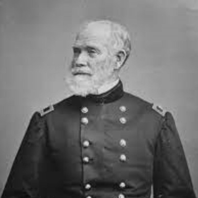 black and white photograph of a grey haired man in a U.S. Military Uniform