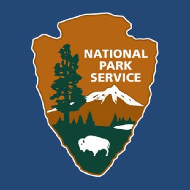 National park service logo of an arrowhead with text reading 