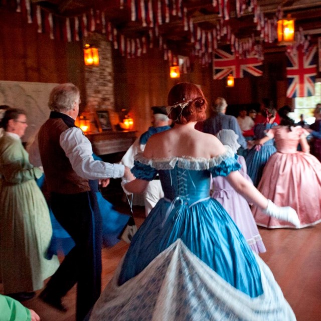 Reenactors dance at the Candle Light Ball during Encampment.