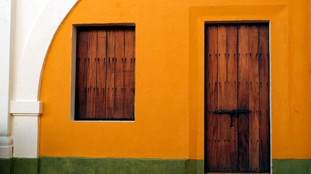 Window and door closed with wooden doors