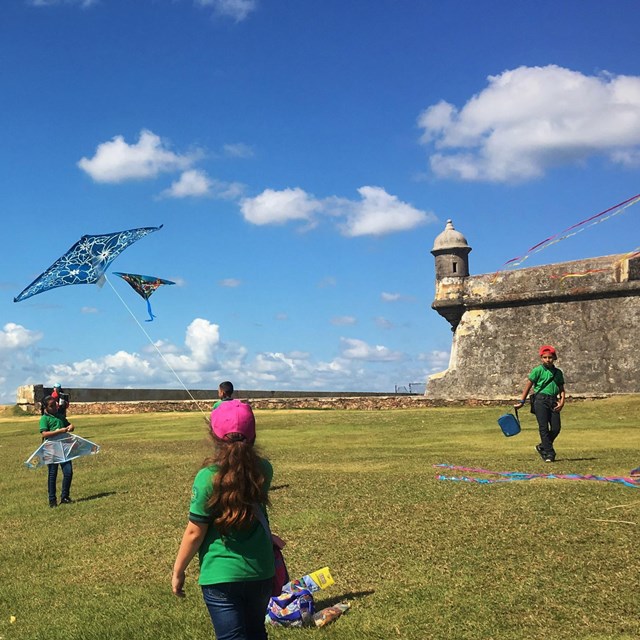 Children flying kites at El Morro