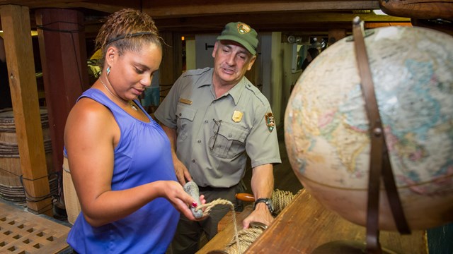 ranger talks to visitor about historic artifacts