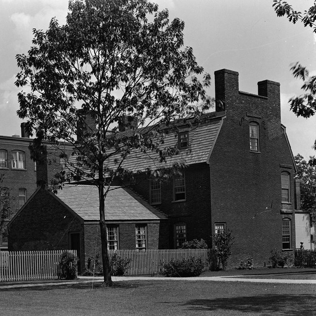 Exterior black and white photo of brick buildings.