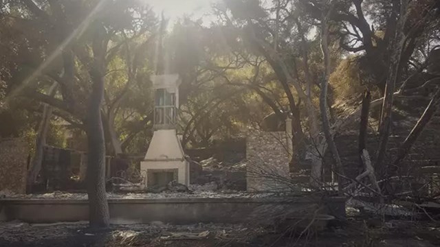 Burned housing structure with a fireplace in the center.