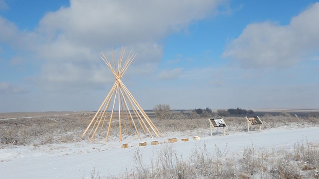 A tipi frame atop Monument Hill