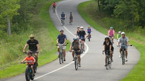 Group of cyclists on paved tour road