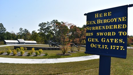 Blue sign commemorating the surrender site for the Battles of Saratoga