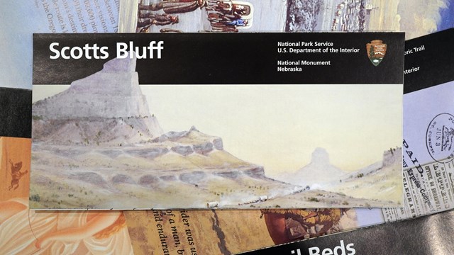 The Scotts Bluff National Monument brochure is seen on top of other park brochures. 