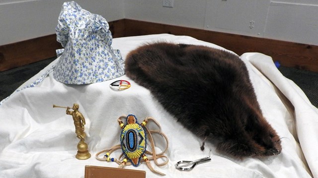 Lesson props are placed on top of a canvas wagon cover.