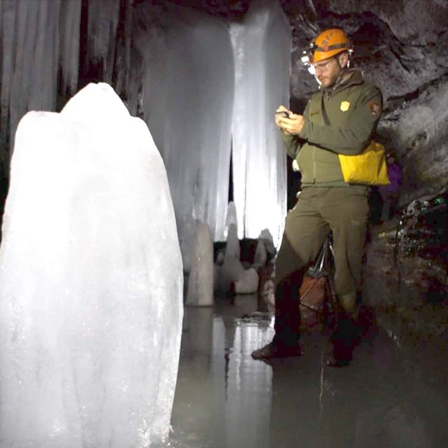 An NPS scientist studying cave features.