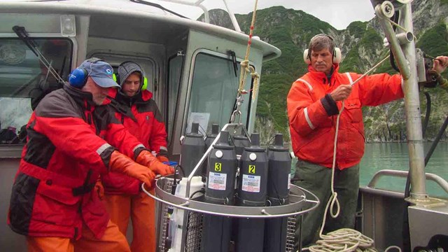 Researchers in a research vessel on the ocean.