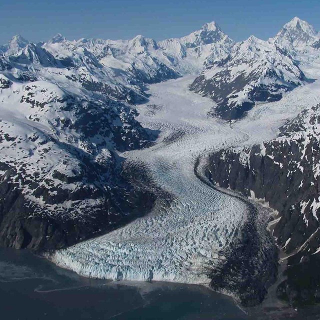 A tidewater glacier winds its way down the mountain in Glacier Bay.