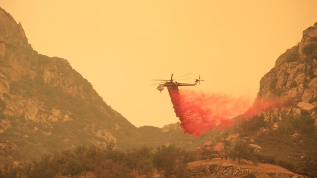 Helicopter drops fire retardant on oak woodlands in the foothills of Sequoia National Park.
