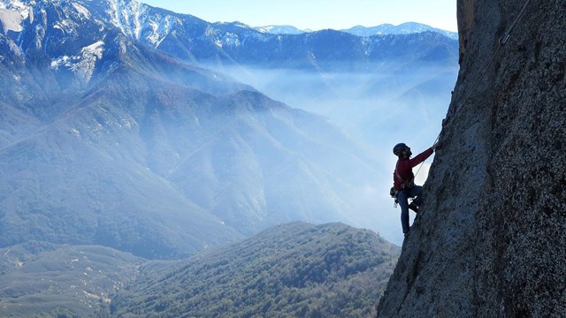 A climber ascends a steep wall. Photo by Daniel Jeffcoach.