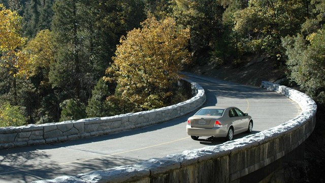 A car drives across the Marble Fork Bridge near Crystal Cave