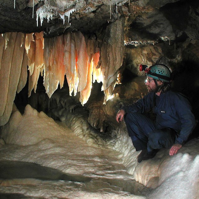 Cave Specialist views a park cave formation.