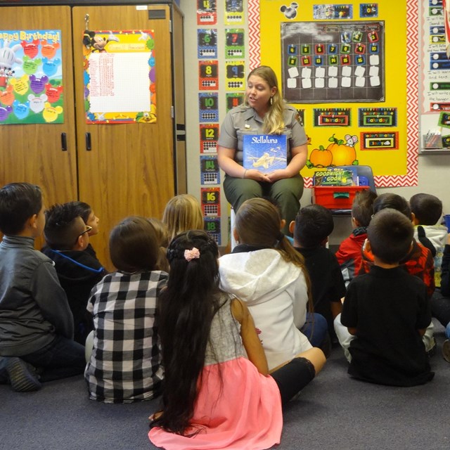A ranger works with students in their classroom