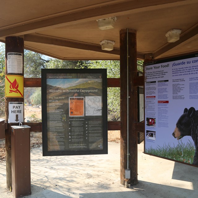 A gazebo at Potwisha Campground features two info panels and a self-serve fee station.