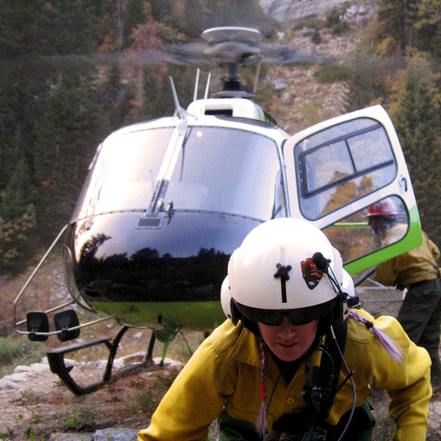 A flight crew member unloads equipment