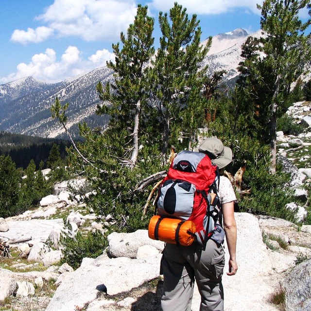 A hiker near an alpine lake