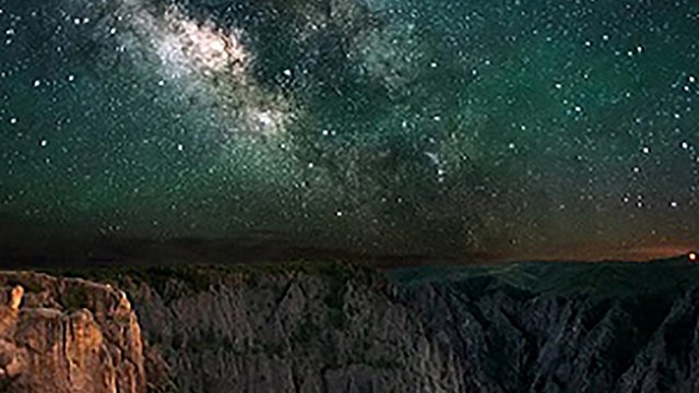 Brilliant night sky over dramatic rock formations
