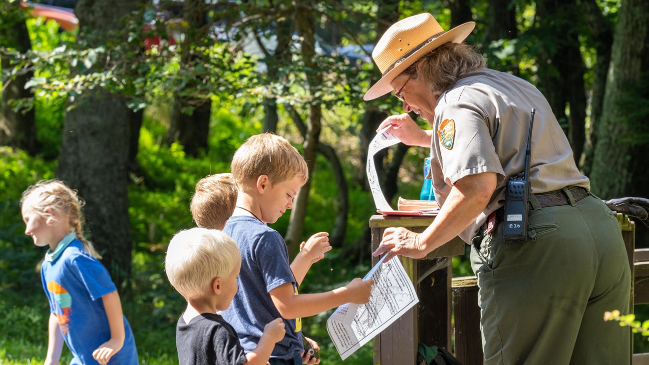 A children interacting with Ranger Mara after a program.