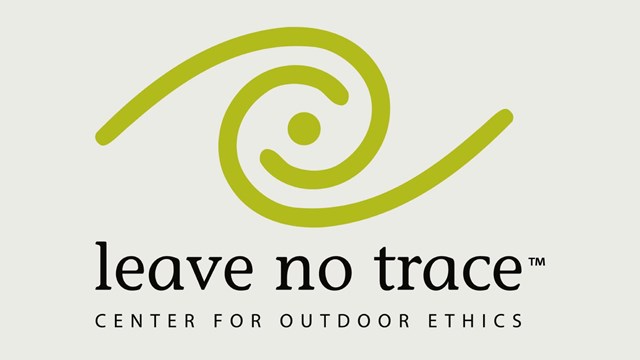 A logo of a green swirl with the words "Leave No Trace Center for Outdoor Ethics" under it.