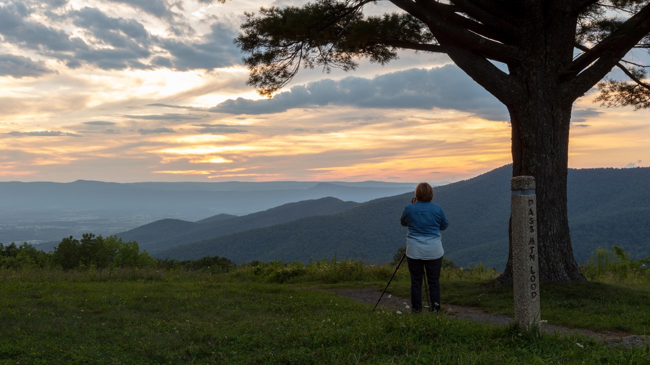 A photographer captures a sunset over the Shenandoah Valley from Pass Mountain Overlook.