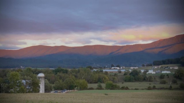 Sunset view looking at purple mountains from the valley. 