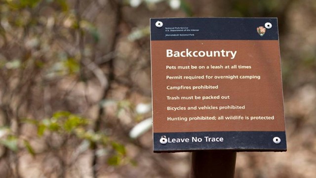 Brown backcountry regulations sign