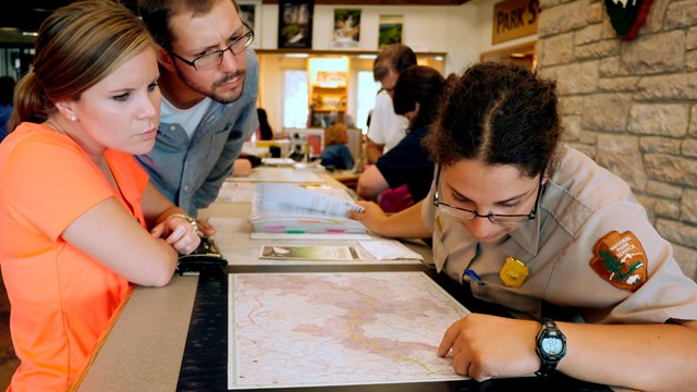 Ranger shows visitors where to go on a map. 