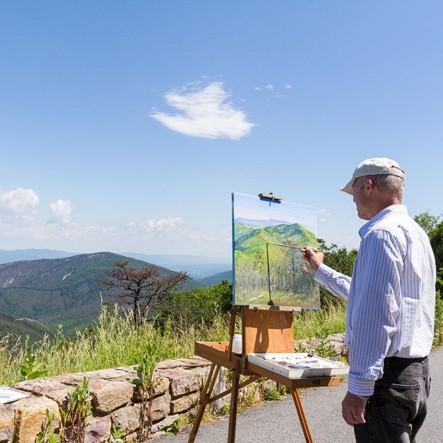 Painting of the park sitting in front of landscape. 