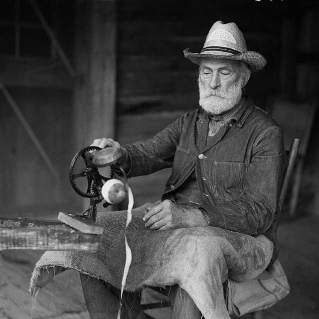 Mountain resident pealing apples. 