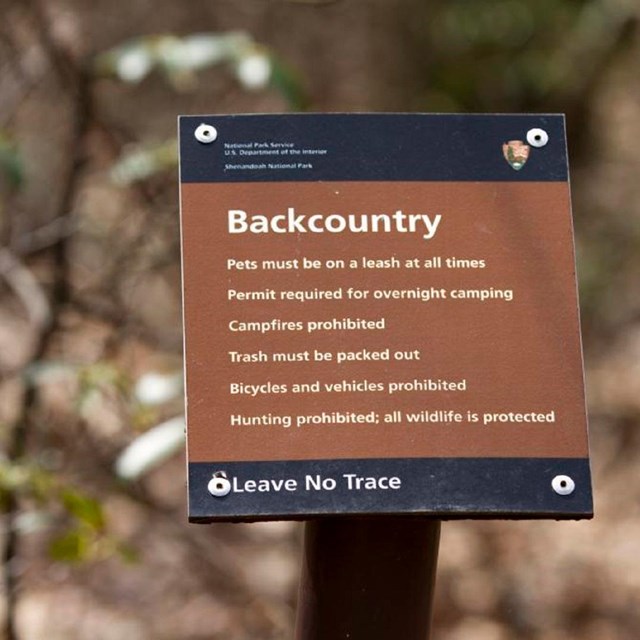 Brown backcountry regulations sign
